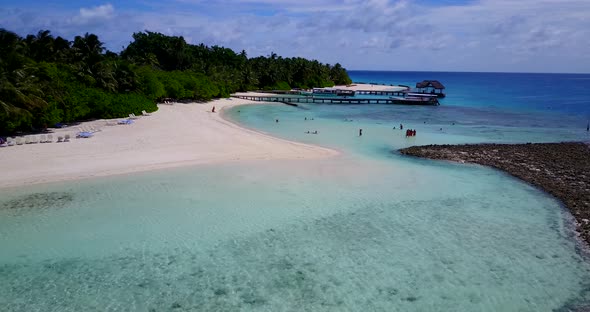 Daytime birds eye tourism shot of a white paradise beach and aqua turquoise water background in colo