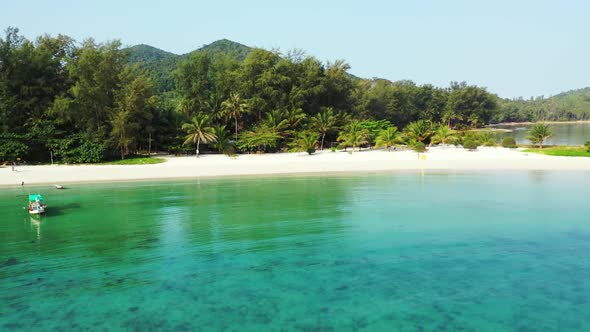 Aerial drone shot landscape of beautiful sea view beach break by shallow lagoon with bright sand bac