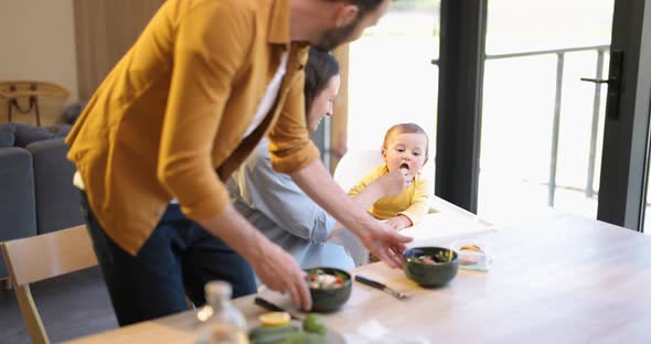 Young Family with a Baby Boy During a Lunch Time at Home