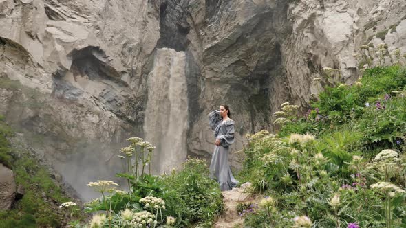 Sexy Brunette Girl with Long Hair Caucasian in a Gray Dress