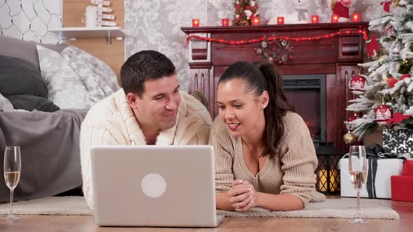 Couple Shopping Online for Christmas Gifts