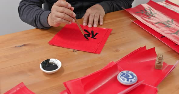 Man Write Chinese Calligraphy for Lunar New Year