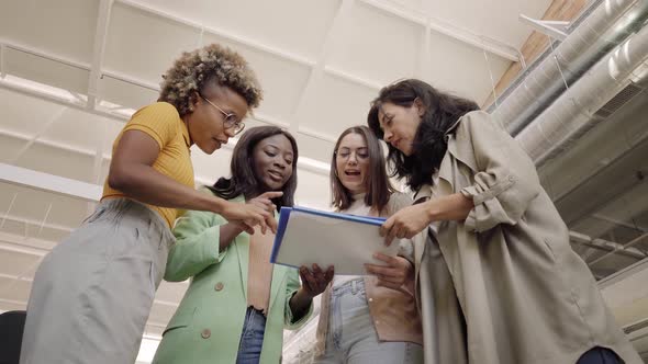 Multiracial Group of Women Working in the Office Discussing New Projects