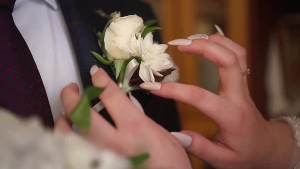 the Bride Wears a Boutonniere to the Groom