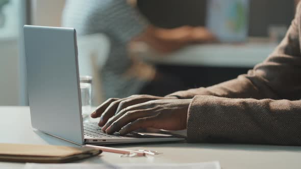 Unrecognizable Man Working On Laptop