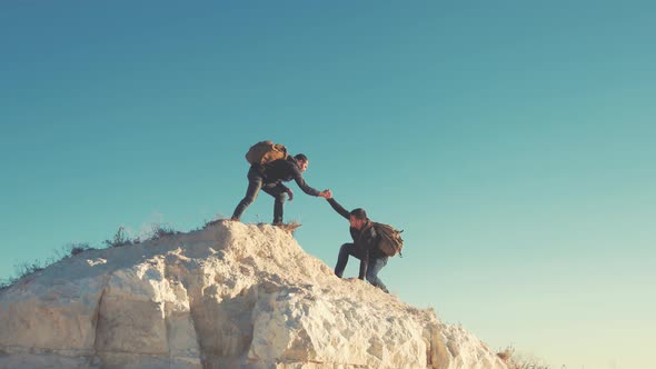 Climber Helping Teammate Climb, the Man with the Backpack Reached Out a Helping Hand To His Friend