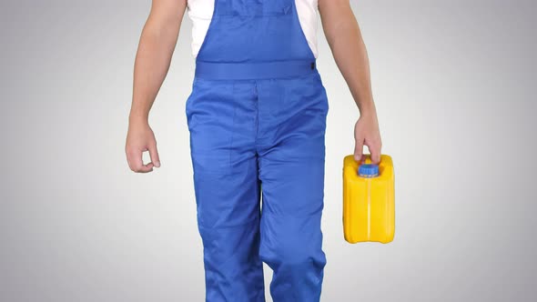 Construction Worker in Hard Hat Holding Plastic Canister and Walking on Gradient Background.