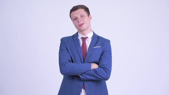 Happy Young Handsome Businessman Smiling with Arms Crossed