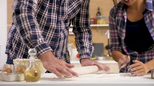 Close Up of Man and Woman at the Kitchen Cooking Together