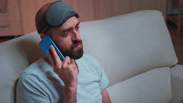 Close Up of Bored Man Talking on Phone with Collegue About Social Media
