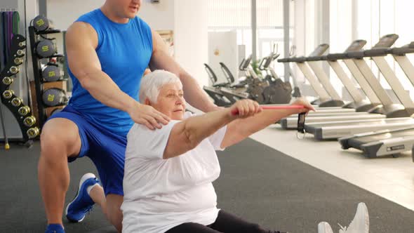 Elderly Pensioner Plays Sports in Gym