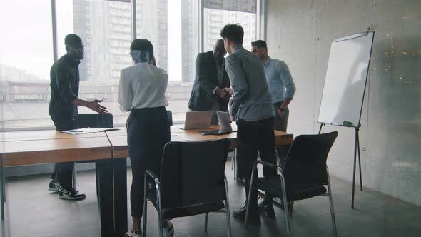 Multiracial Diverse Business Team Partners Coworkers Stand in Boardroom at Meeting Shake Hands Do