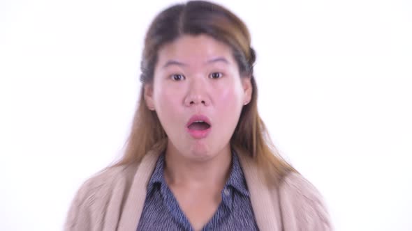 Face of Young Asian Woman Looking Shocked Ready for Winter