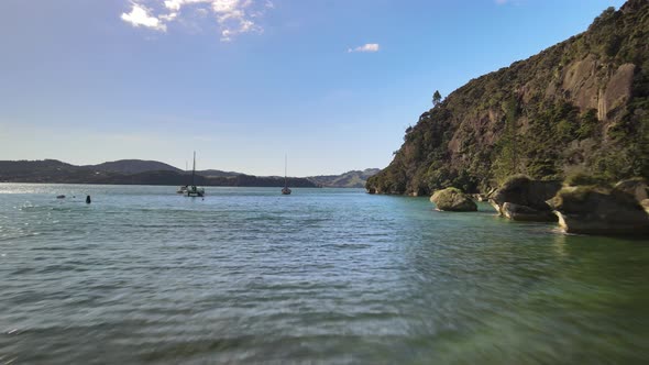 Flying past floating boats moored in Ferry landing, New Zealand