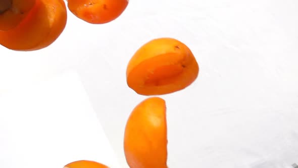 Halves Ripe Apricots Fly on White Background
