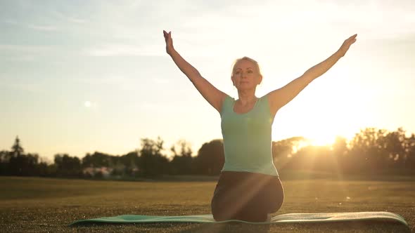Fitness Woman Exercising Yoga Poses at Sunset