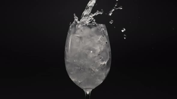 Mineral Water Pouring Ice Glass Closeup