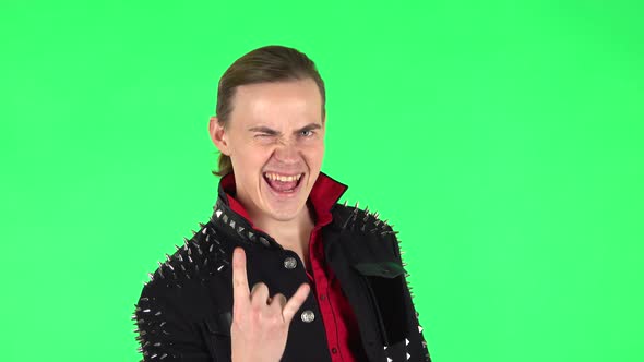 Guy Making a Rock Gesture, Enjoying Life and Laughing. Green Screen