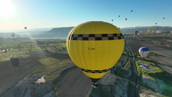 4K Aerial view of Goreme. Colorful hot air balloons fly over the valleys.