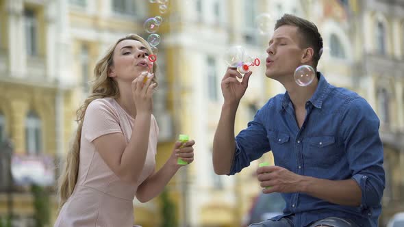 Girlfriend and Boyfriend Making Soap Bubbles and Kissing, Sweet Relationship