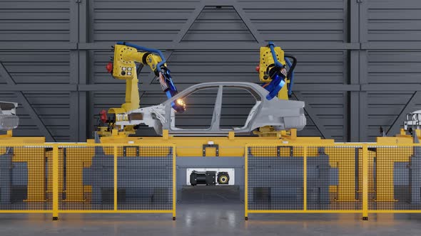 Car frame on slide conveyor on the Automobile Plant with Spot Welding Robots.