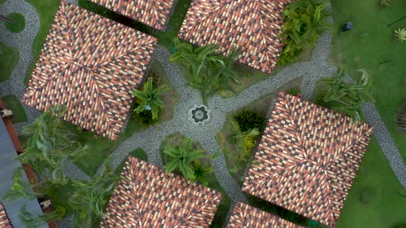 Top down aerial shot of a coastal beach resort and huts in Costa Rica