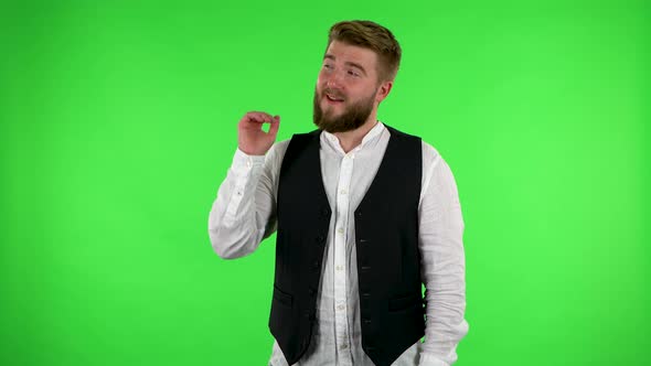 Man Talking and Pointing Side Hand for Something, with Copy Space. Green Screen