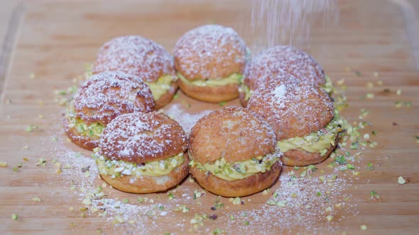 Veiled Sugar is Put on Top of Tasty Pastries with Cream