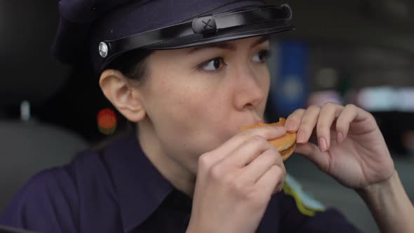 Patrol Woman Feeling Unpleasant Taste Eating Burger, Low Quality of Street Food