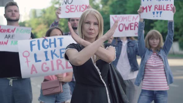 Confident Caucasian Woman Crossing Hands in No Gesture on Demonstration Against Sexism and Women