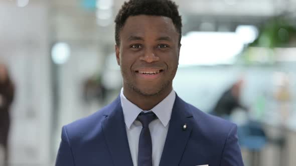 Portrait of Attractive African Businessman Smiling at Camera