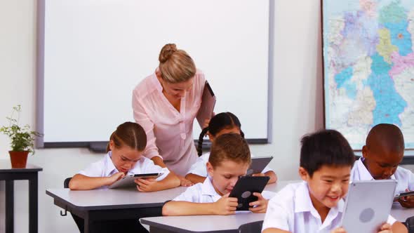 Students using digital tablet in classroom