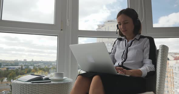 Businesswoman talking with colleagues by video conference call