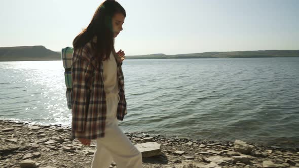 Woman with Backpack Walking on Riverside of Bakota Bay