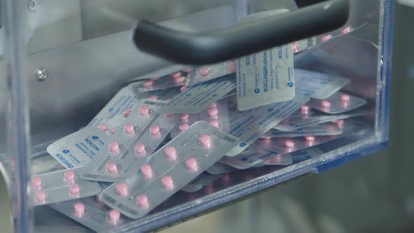 The Pills Filled and Packaged in Blister Pack are Falling Down to the Container