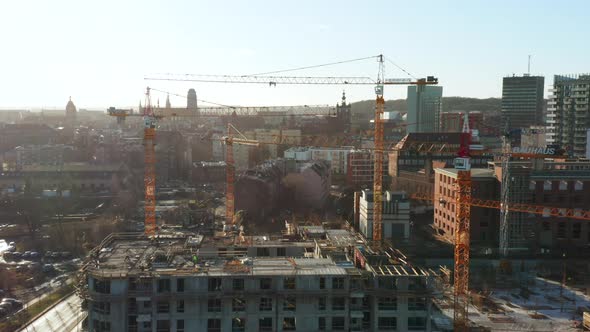 Aerial View of a Construction Site with Cranes and Heavy Machinery alt