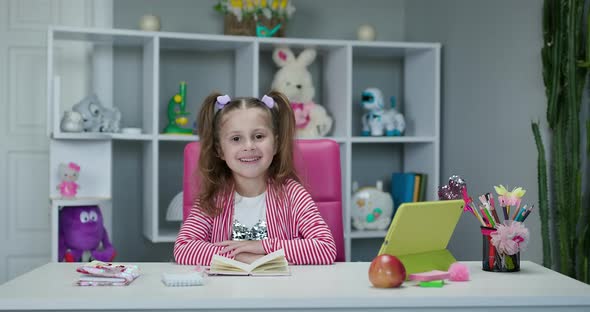 Portrait of Preschool Girl Looking at the Camera and Smiling