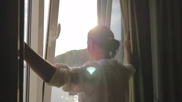 Lovely Girl is Awake and Standing Before Window