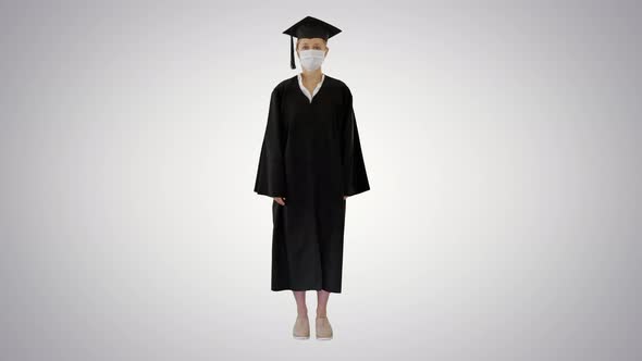 Female Graduate Student in a Medical Mask Standing on Gradient Background.