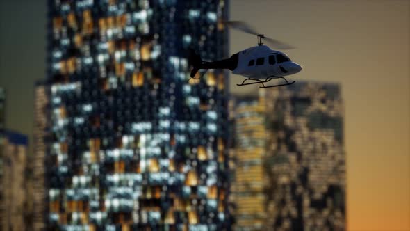 Slow Motion Helicopter Near Skyscrapers at Night alt