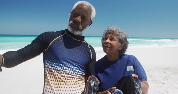 Senior couple taking photos at the beach