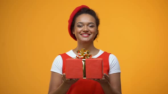 Cheerful Woman Stretching Hands Showing Into Camera Red Giftbox, Holiday Present