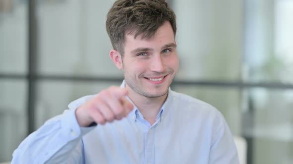 Young Man Pointing at the Camera