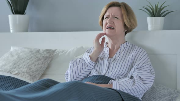 Toothache, Old Senior Woman with Tooth Pain Sitting in Bed