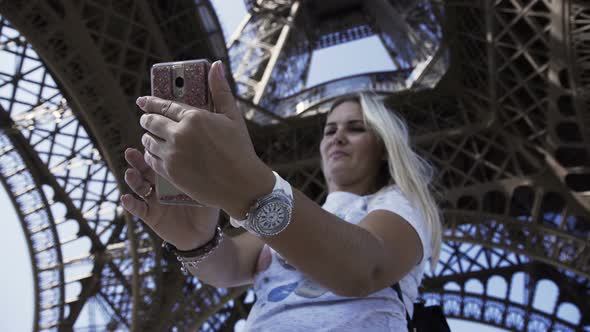 Happy Woman Taking Selfie Under Eiffel Tower