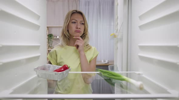 Hungry Woman Opening Fridge Looking Inside Searching for Food and Disappointed but Problem Can Be