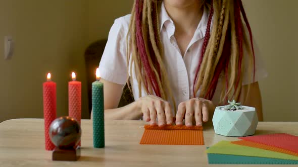 Young Modern Girl with Dreadlocks in White Shirt Is Performing a Workshop of Making Beeswax Candles