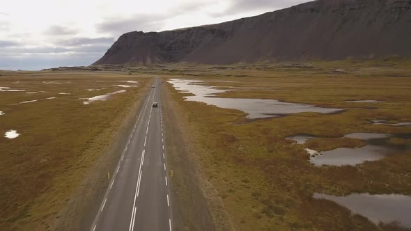 a drone video of a car in iceland highway