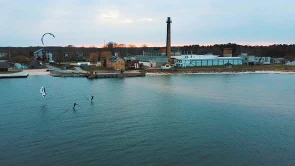 Aerial Drone View of a Corekites Kitesurfers Hydrofoiling  in Engure Port at in Baltic Sea