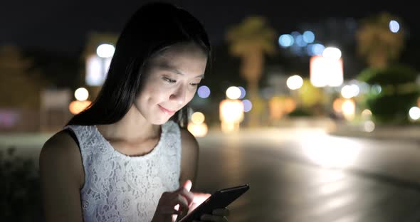 Woman use of smart phone at night 